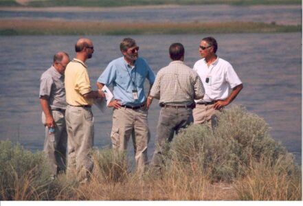 Five men talking near Columbia River.
